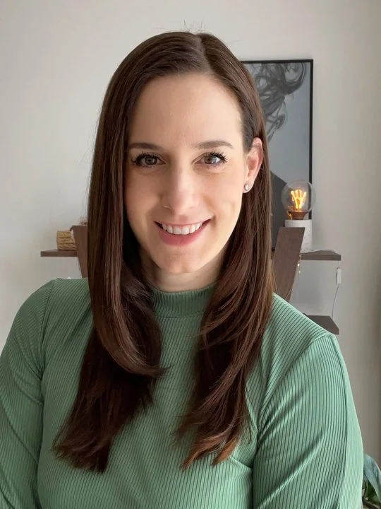 Kata Török-Pál smiling in her home office